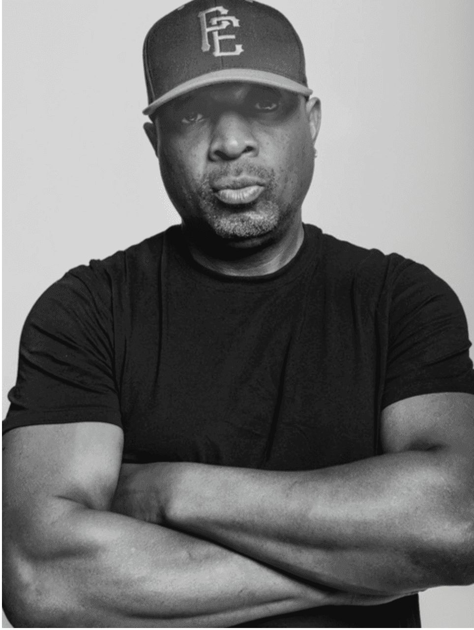 Chuck D of Public Enemy, black and white portrait, arms crossed